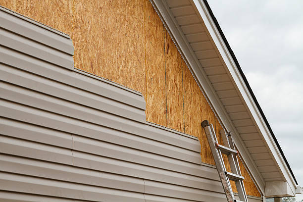 Professional Storm Damage Siding Repair technician working in Wolcott, IN